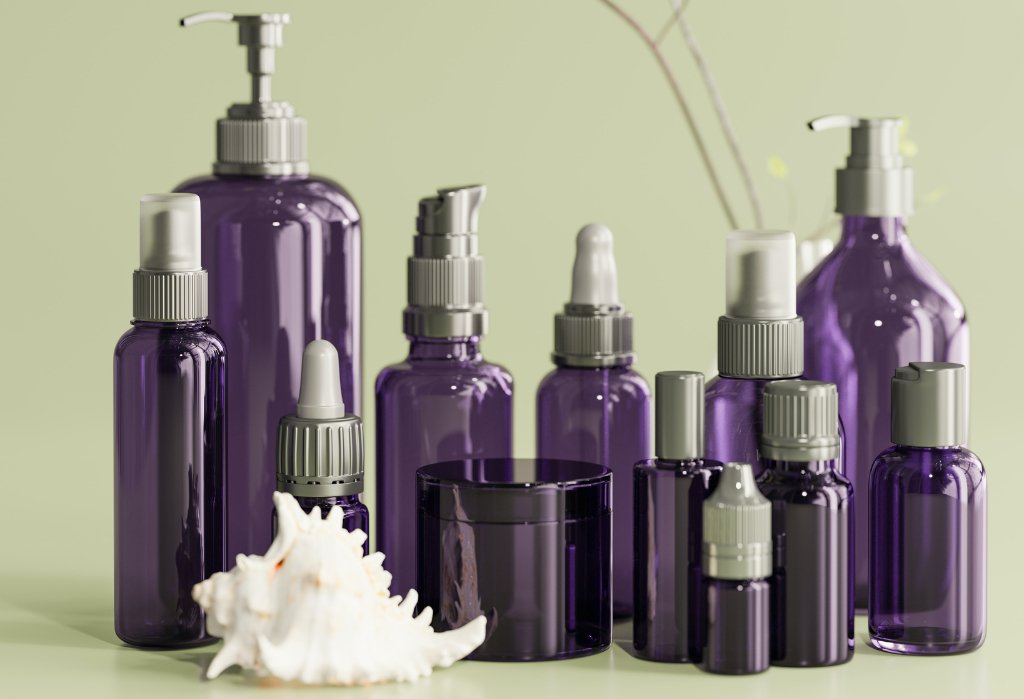 Photo of purple glass bottles collection, pumps and sprays and lotion, no labels, to represent creating your own essential oil mixes