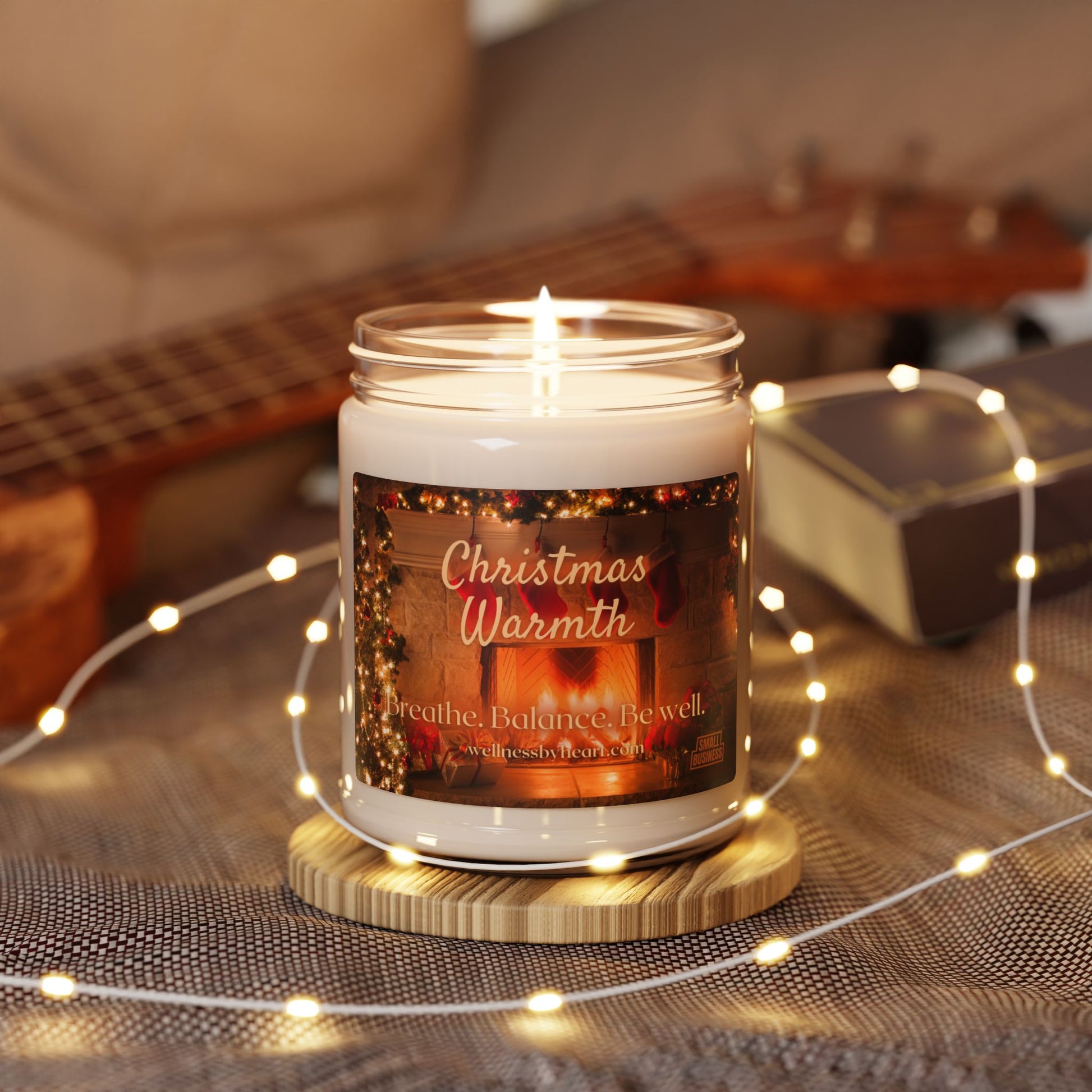 christmas warmth candle in boho scene lit with fairy light