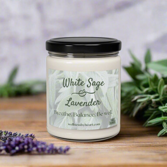 White Sage and Lavender Essential Oil Soy Candle Sitting on a table with fresh sage and lavender. wellness by heart