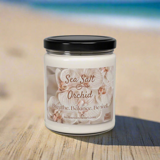 Sea Salt & Orchid Essential Oil Scented Candle from Wellness by Heart - on table with beach in background main photo