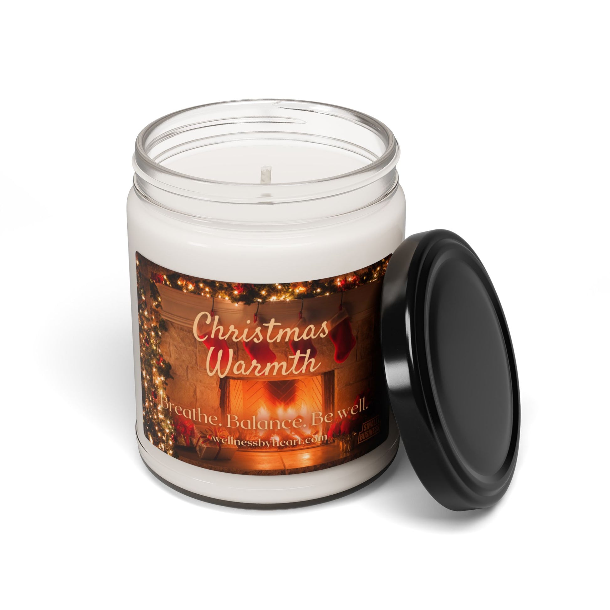 chrustmas warmth essential oil soy candle with jar lid off and white background