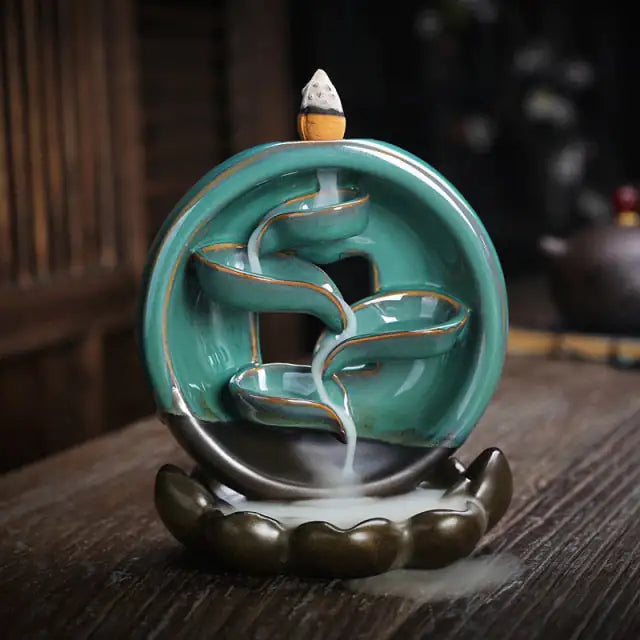 Stylized photo of incense burner with dark wood table and dim lit background from wellness by heart aromatherapy product collection